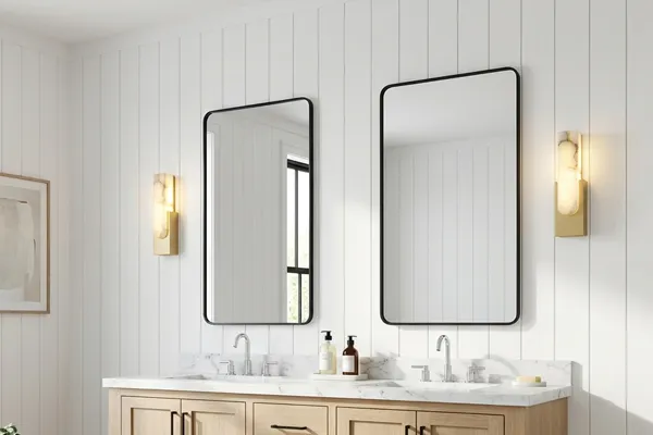 Pair of alabaster brass sconces flanking bathroom mirrors